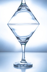 two empty glasses stand on top of each other on a white background