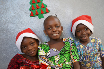 Wall Mural - Boys and Girls Celebrate Christmas together Smiling and Laughing