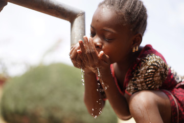 Wall Mural - Health and Hygiene symbol, Black Young Girl Drinking Fresh Clean Water from Tap