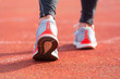 close up view of an athlete getting ready for the race on a running track . Focus, on shoe of an athlete about to start a race in stadium .