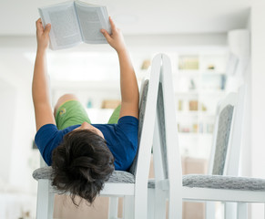 Wall Mural - Boy at home reading book