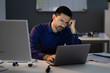 © Andrey Popov - Stressed Accountant Working Late In Office