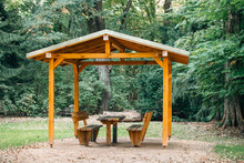 Covered Seating Area. Gazebo, Pergola In Parks And Gardens - Relax And Unwind. Wooden Gazebo In The Park