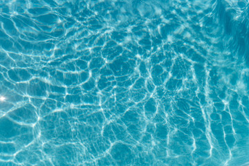 Beautiful refreshing blue swimming pool water. Background of blue water in the pool