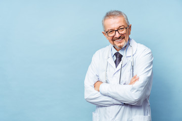 Cheerful mature doctor posing and smiling at camera, healthcare and medicine.