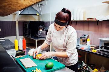 female chef preparing a sushi restaurant in the kitchen