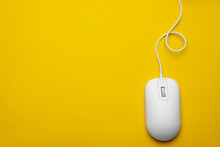 Wired Computer Mouse On Yellow Background, Top View. Space For Text