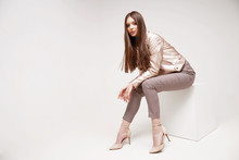 Fashion Model In Golden Leather Jacket Posing In Studio.