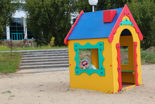 Girl Plays On The Playground. Sandbox House