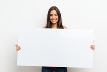Young Woman Over Isolated White Background Holding An Empty White Placard For Insert A Concept