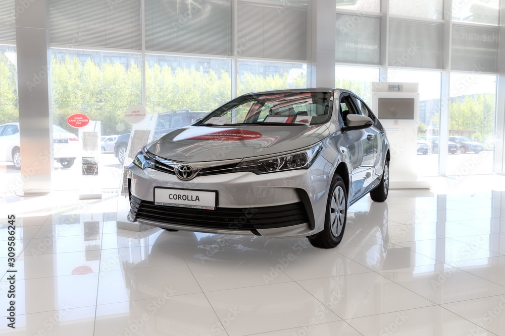 Selling cars Toyota in the showroom. New products automaker Toyota