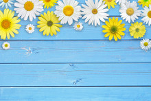 White And Yellow Daisy Flowers On Blue Wooden Table Background. Beautiful Spring Composition, Template For Design, With Copy Space For Text.