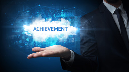 Hand of Businessman holding ACHIEVEMENT inscription, successful business concept