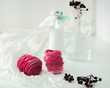 Handmade air russian fruit pink marshmallow on a white background with beautiful bottles and dry berries. Homemade Sweets.