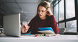 © GalakticDreamer - Thoughtful female watching movie online for writing review on modern netbook, young hipster girl learning at school library using computer and for doing homework and autodidact during web courses