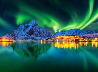 aurora borealis over winter landscape - lofotens - norway