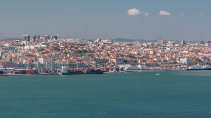 Wall Mural - Panorama of Lisbon historical centre aerial timelapse viewed from above the southern margin of the Tagus or Tejo River.