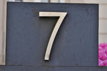 A House Number Plaque, Showing The Number Seven (7)