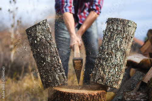 Lumberjack chopping wood for winter, Young man chopping woods with an axe Tableau sur Toile