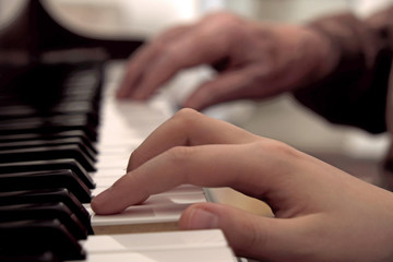 Boy and Grandfather play piano together