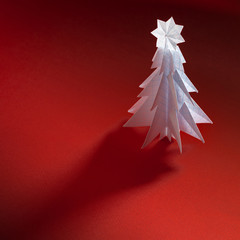 Wall Mural - Christmas trees made of paper on red background. Christmas card