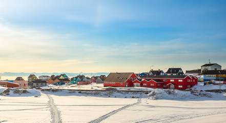 Wall Mural - Arctic city center panorama with colorful Inuit houses at the fjord covered in snow, Ilulissat, Avannaata municipality, Greenland