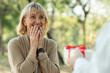 © khwanchai - Beautiful elderly woman surprise with gift from husband in park, Take care and thank you of love concept