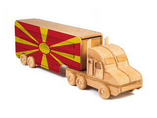 Close-up of a wooden toy truck with a painted national flag Macedonia. The concept of export-import,transportation, national delivery of goods