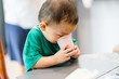 © MIA Studio - Little asian toddler boy drinking beetroot juice in breakfast time.