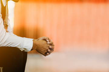 Man praying on holy bible in the morning.teenager boy hand with Bible praying,Hands folded in prayer on a Holy Bible in church concept for faith, spirituality and religion