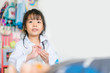 © MIA Studio - Cute smiling asian girl dressed like a doctor.Smiling little girl playing doctor with Otoscope at home.Doctor, Health care and Occupation Concept.