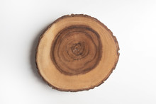 Cross Section Of Tree Stump On White Table Flat Lay Top View. Wooden Cut Section.