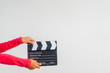 © MIA Studio - Kid hands holding clapper board for making video cinema in studio.Movie production clapper board or slate film concept.