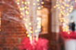 Abstract blur. Street in a Christmas day in an old European town. Lamps garlands, christmas decor and decorations