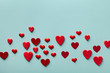 © juliasudnitskaya - Valentine day greeting card or banner. Red hearts on blue background top view. Flat lay style.