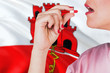 © sezerozger - Gibraltar health care concept. Close-up of a woman taking vitamin capsule on national flag background.