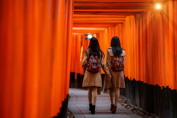 Wall Mural - traveller girl walk togater in Fushimi temple