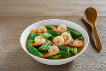 Hot And Sour Okra Soup With Shrimp In A Bowl On Wooden Table, Close Up. Asian Homemade Style Food Concept.