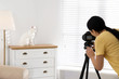 © New Africa - Professional animal photographer taking picture of beautiful white cat indoors