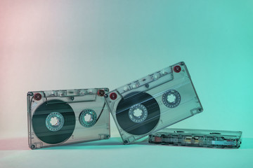 Beautiful Audio cassette tape in neon  light.Minimalism retro style concept. 80s. Background pattern for design.