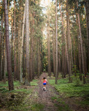 Fototapeta Dziecięca - Young woman running on the forest road