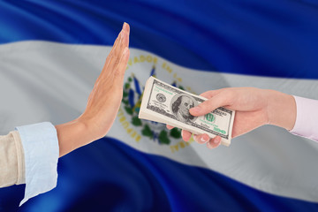 El Salvador bribery refusing. Closeup of female hands extending a pile of dollar bills to the male hands gesturing as if rejecting the money.