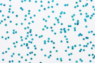 Wall Mural - iridescent blue color stars. glitter confetti on white festive background. holiday sparkles. flat la