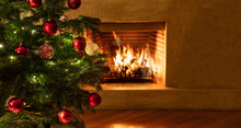Christmas Tree Close Up On Burning Fireplace Background