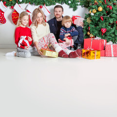 Cheerful family with Christmas gifts