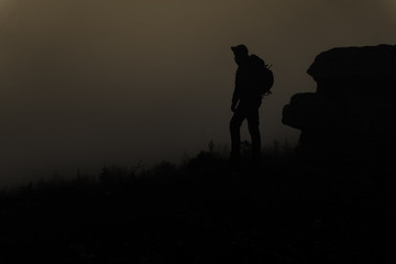 silhouette of man on top of mountain