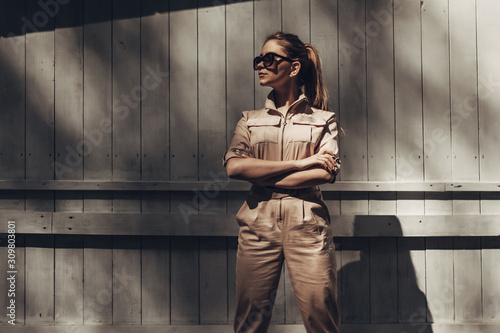 Cuadros en Lienzo Portrait of Stylish Girl Wears Women Overalls and Black Sunglasses