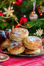 Homemade Christmas Puff Pastry Mince Pies With Christmas Tree In The Background