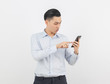 © Touchr - Young handsome asian business man playing smartphone with smiling isolated on white background.