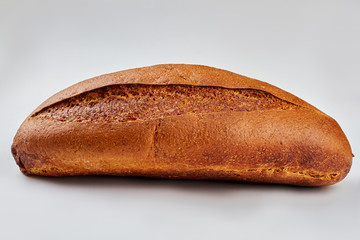 Crispy loaf of bread on white background. Freshly baked bread. Healthy food concept.